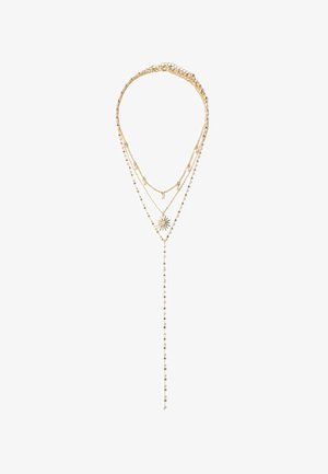 Collier à plusieurs chaînes en plaqué or, ornés d'un pendentif en forme de soleil et de petites perles blanches, créant un design délicat et complexe.