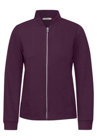 Veste zippée violette avec un col haut, fabriquée en tissu lisse, dotée de deux poches latérales et de poignets côtelés.