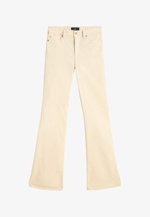 Beżowe spodnie z rozszerzanymi nogawkami wykonane z miękkiej bawełny, wyposażone w zamek błyskawiczny, przednie kieszenie oraz złote metalowe akcenty na kieszeniach.