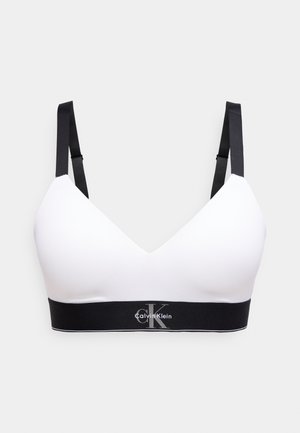 Sutien alb în formă de triunghi cu bretele negre reglabile și bandă elastică neagră cu logo-ul Calvin Klein în alb și gri.