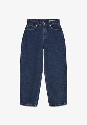 Tumedast sinisest denimist teksad, sirge lõikega, viie taskuga ja nähtava õmblusega. Omab esist nuppu ja tõmbluku sulgemist.