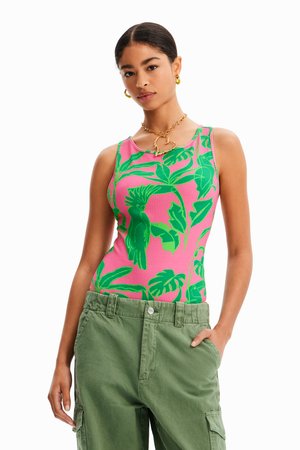 Top sin mangas color rosa con estampado de hojas tropicales verdes; textura acanalada; combinado con pantalones cargo verdes casuales.