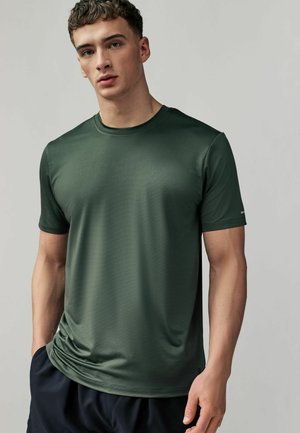 Dark green short-sleeve athletic shirt made of textured fabric, featuring a crew neckline and a subtle logo detail on the sleeve.