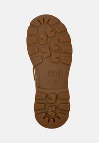 Brown rubber outsole with textured patterns, featuring a deep tread for grip. Markings include "CAMPE" and "BRIDGE XTRAGRIP," size 38.