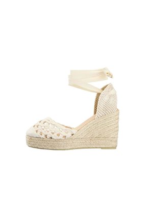 Sandalia cuña espadrille beige con diseño tejido de puntera abierta, talón cerrado y lazadas para atar en el tobillo.
