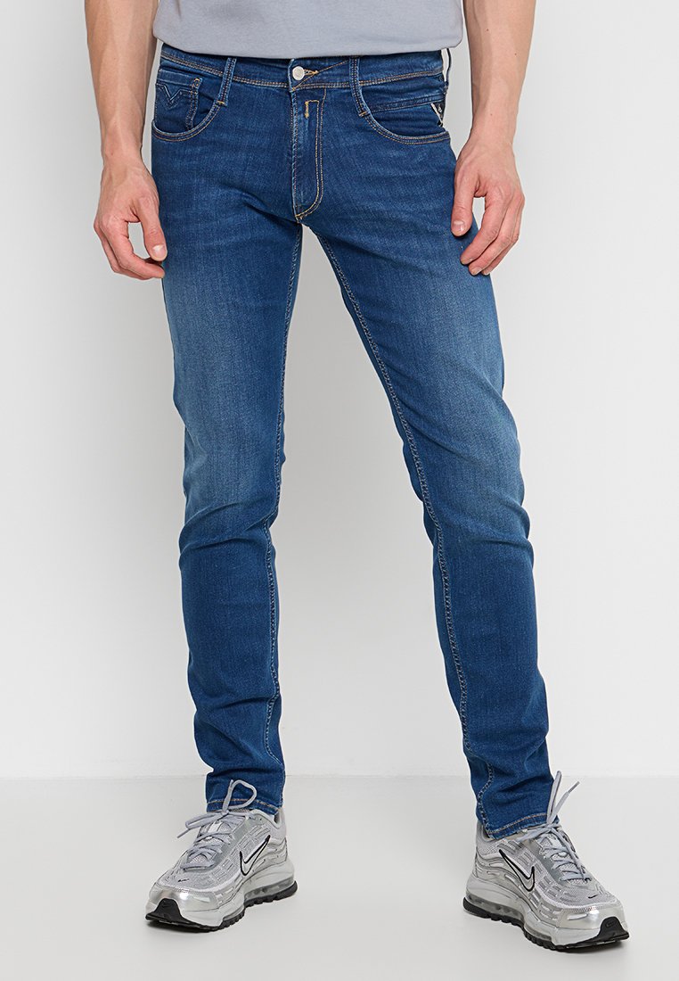 Ciemnoniebieskie dżinsy o slim fit, z klasycznym pięciomasztowym fasonem, kontrastowym przeszyciem i zamkiem błyskawicznym.