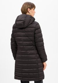Black puffer coat featuring a hood, vertical quilted design, mid-length cut, and soft, smooth texture, suitable for cold weather.