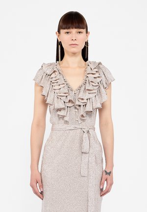 Gerimpelde blouse in een lichte metallic stof, met een diepe V-hals en knoopdetails, en een bijpassende strikceintuur rond de taille.