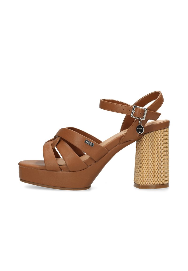 Brown platform sandals with cross straps, a chunky woven heel, and a metallic buckle accent. Smooth texture with a rounded toe design.