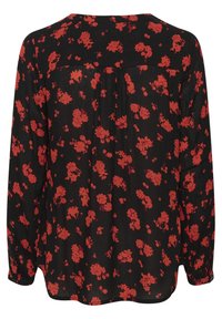 Zwarte blouse met lange mouwen, voorzien van een bloemenpatroon in het rood. Zachte stof, losse pasvorm, met een subtiele plooidetail aan de achterkant.