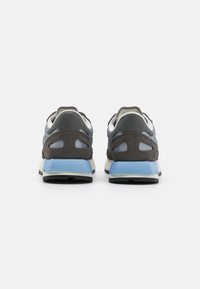 Sneakers featuring a grey and blue color scheme, suede and mesh textures, rounded shape, with a blue heel accent and mesh cutouts.