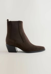 Brown suede ankle boot with a pointed toe, elastic side panels, a pull tab, and a stacked black heel. Solid texture and sleek design.