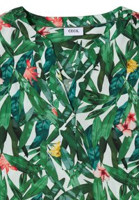 Blouse verte à motifs feuillus avec des fleurs tropicales roses et jaunes et un col en V étiqueté "CECIL".