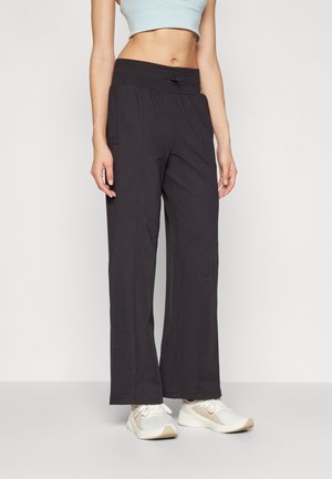 Black, wide-leg pants with a stretchy, elastic waistband and side pockets, made from lightweight fabric suitable for activewear or casual use.