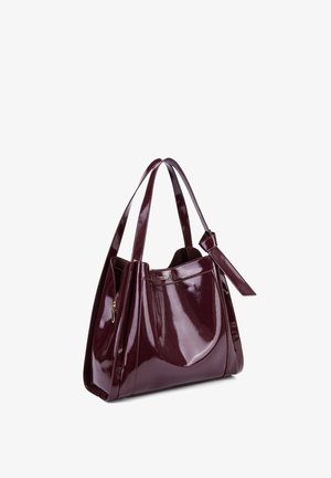 Sac à main en cuir verni bordeaux avec un design structuré, des double anses et une poche zippée sur le côté pour le rangement. Texture lisse sur l'ensemble.
