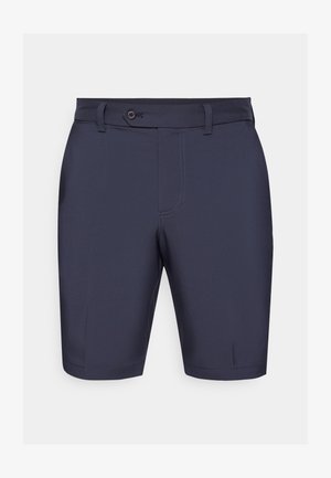 Námořnické modré kraťasy s plochým předním dílem, knoflíkovým uzávěrem, poutky na opasek a jemnými stehy. Vyrobené z hladkého, lehkého materiálu.