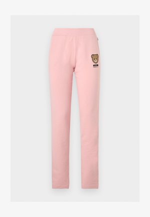 Pantalones ajustados de color rosa claro con cintura elástica, pequeño logo de oso de peluche y texto "Moschino Underwear" en la cadera izquierda.