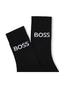 Sorte bomullssokker med hvit "BOSS"-logo brodert på yttersiden, med ribbestrikkede mansjetter og glatt tekstur.