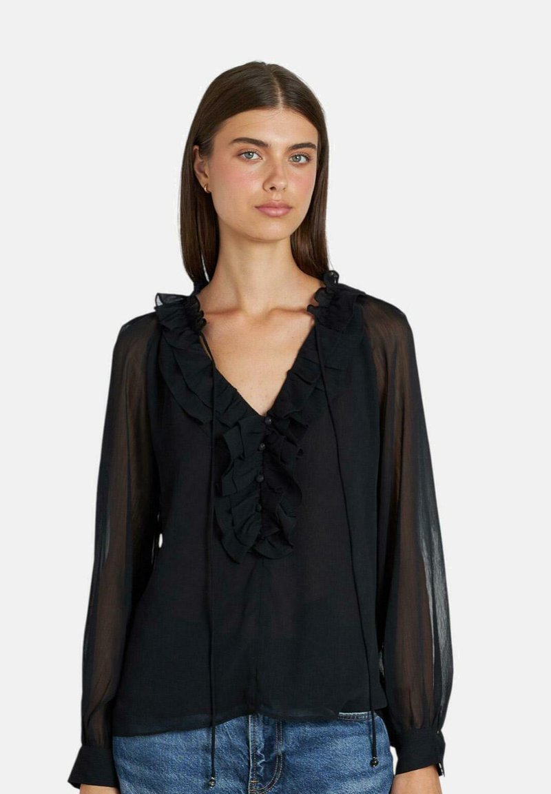 Schwarze Chiffonbluse mit langen Ärmeln, V-Ausschnitt, Rüschen-Details und Knöpfen auf der Vorderseite. Leichter, durchsichtiger Stoff und verstellbare Bänder am Ausschnitt.
