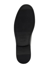 Suola di scarpa nera con superficie testurizzata, caratterizzata da una fascia centrale liscia e il logo "MNG" in rilievo. Forme ovali e rettangolari sono predominanti.