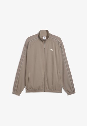 Hellbraune Puma-Jacke mit Reißverschluss und Stehkragen, weißes Puma-Logo auf der Brust, Seitentaschen und weiße Nähte entlang der Ärmel.