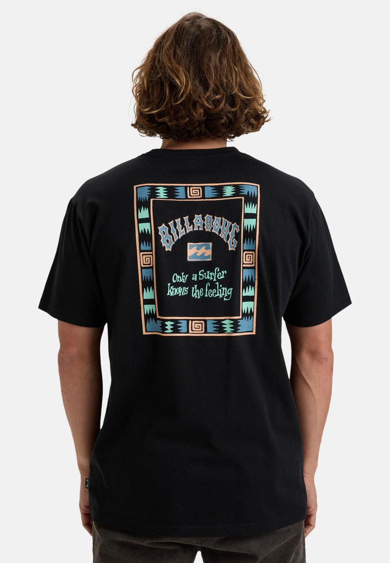 Black cotton t-shirt with colorful geometric print featuring the "Billabong" logo and text. Relaxed fit, short sleeves, and minimal design.