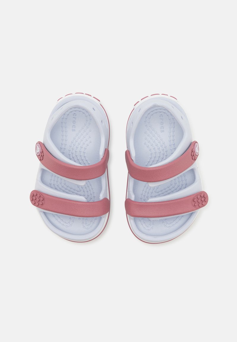 Rosa und weiße Sandalen mit zwei verstellbaren Riemen, einem strukturierten Fußbett und einer soliden weißen Sohle mit einem gemusterten Profil.
