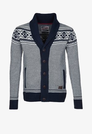 Marineblauwe en witte gebreide cardigan met sjaalkraag, knopen aan de voorkant, geometrische patronen op de schouders en twee voorzakken.