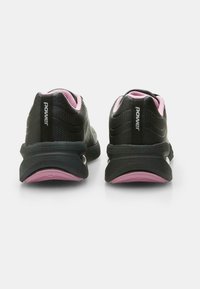 Black athletic shoes with pink accents, featuring a textured upper, cushioned sole, and branding on the heel. Rear view shows streamlined design.