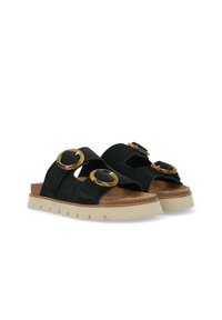 Sandali neri in suedè con due sovradimensionati accenti circolari, soletta in sughero e suola in gomma beige con un design di battistrada testurizzato.