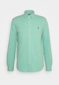 Long-sleeve button-up shirt in light green with button-down collar and small embroidered logo on left chest.
