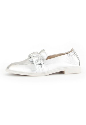 Silver metallic loafers with a flat sole, knot detail on the front, and a smooth texture. Minimalist design with no visible hardware.