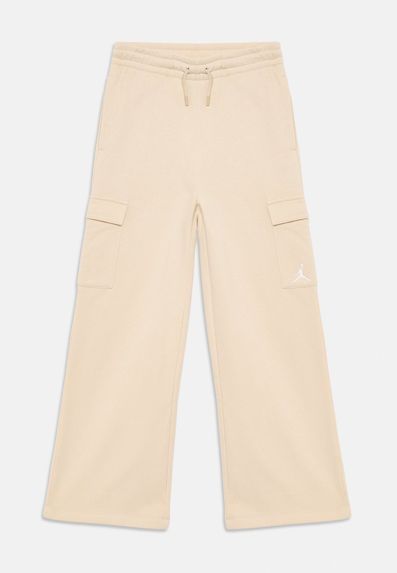 Beige wide-leg cargo pants with elastic waistband, drawstring, side flap pockets, and small white Jumpman logo on right pocket.