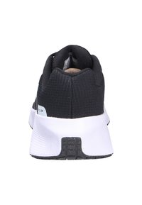 Scarpe sportive in tessuto nero con un upper testurizzato, colletto imbottito e una suola bianca ammortizzata con una superficie di aderenza a motivi.