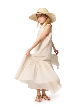Light cream sleeveless dress with gathered skirt, featuring subtle texture. Paired with a wide-brimmed straw hat and brown sandals.