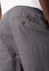 Gray linen shorts featuring an elastic waistband, a back pocket with a button closure, and an ECOALF label on the left side.
