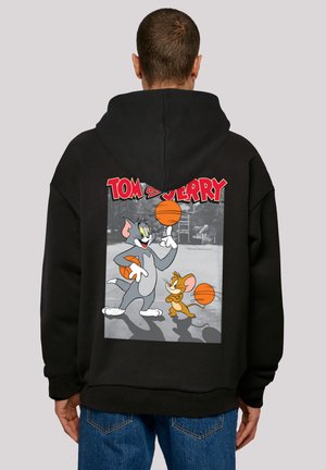 Black hoodie featuring a colorful print of Tom and Jerry playing basketball, with the text "TOM and JERRY" at the top. Cotton blend material.