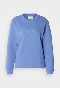 Felpa blu in cotone con scollo rotondo, maniche lunghe e polsini a coste. Presenta il marchio ricamato "GANT" e "NEW HAVEN".
