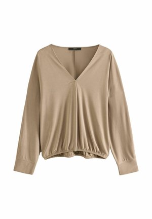 Blouse beige à manches longues avec col en V, ourlet froncé et larges poignets, présentée sur fond blanc.