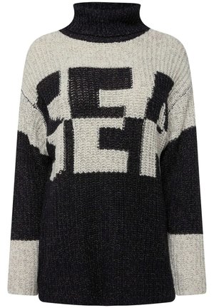 Strik oversize sweater med høj krave, sort og cream farver samt fede blokbogstaver. Tekstureret stof med en løs pasform.