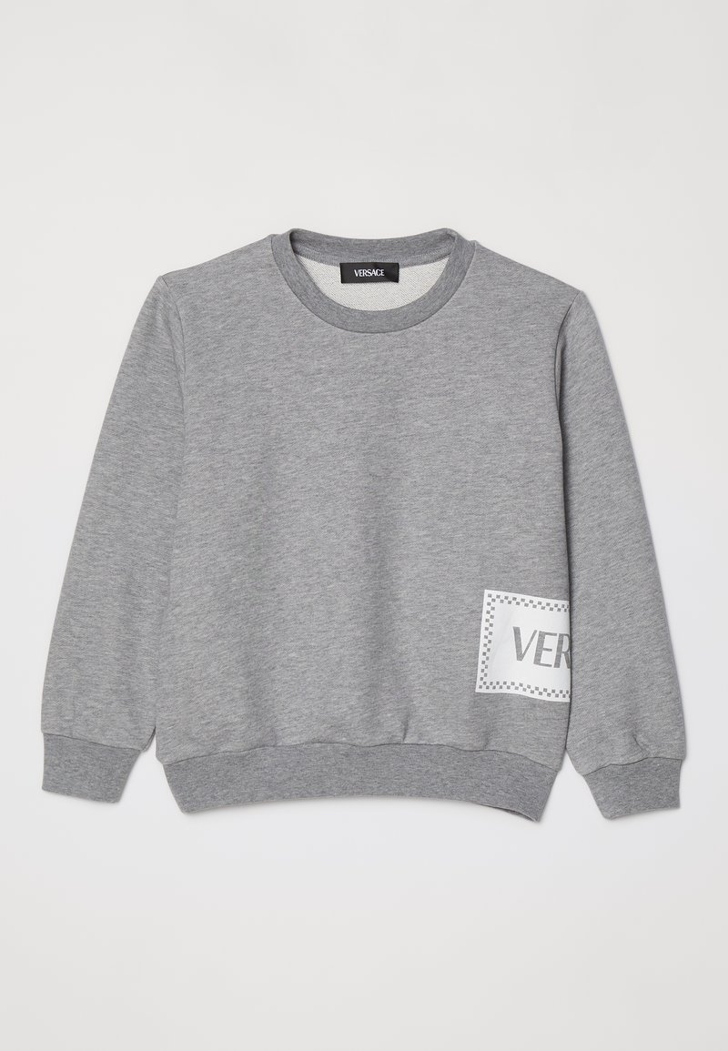 Gray sweatshirt with long sleeves, ribbed cuffs, and hem. Features a white patch with "VER" text design. Made from a soft, textured fabric.