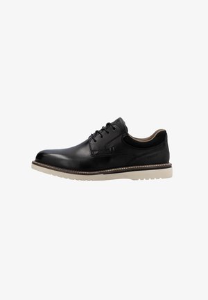 Black leather dress shoe with smooth finish, round toe, lace-up design, and beige sole. Features stitching details along the edge.