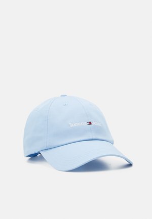 Light blue baseball cap with curved brim and "Tommy Jeans" embroidered in white with a small red, white, and blue flag logo.