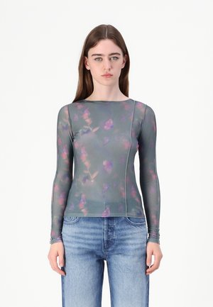 Long-sleeve top in sheer teal fabric with a floral pattern in pink and purple. Features a round neckline and fitted silhouette.