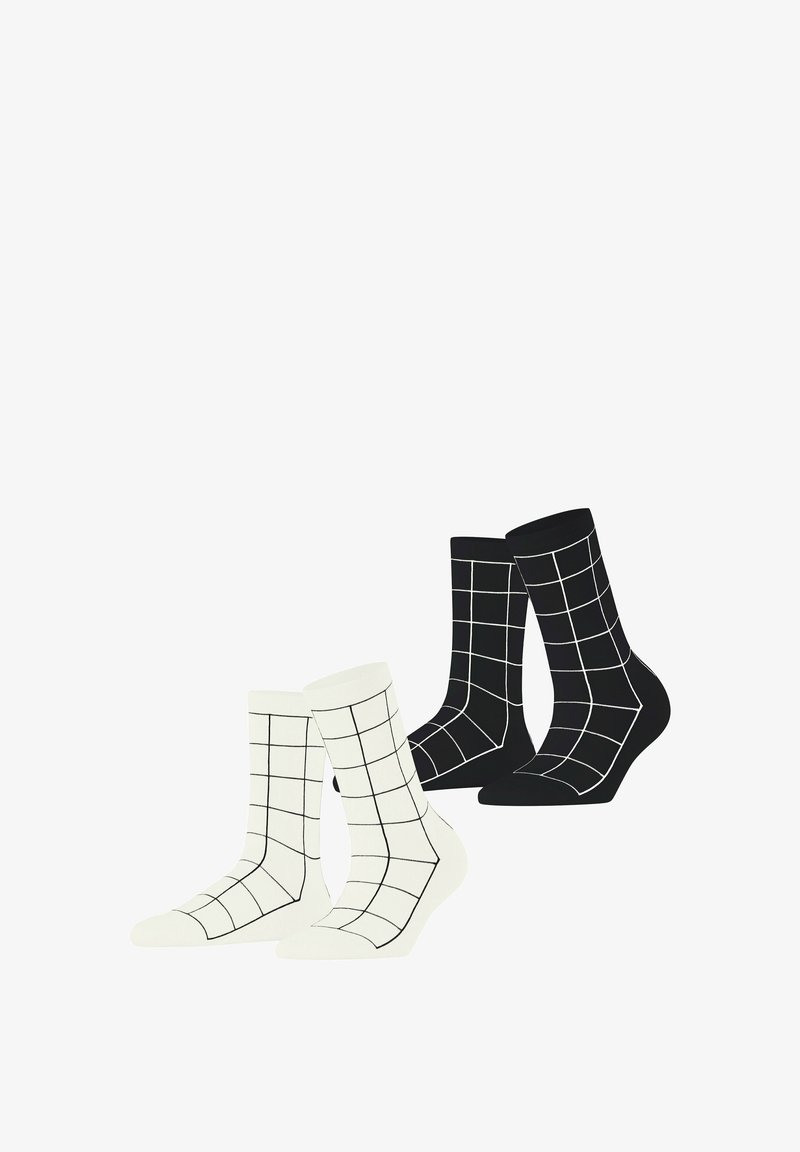 Two pairs of crew socks: one white with a black grid pattern, and one black with a white grid pattern. Made of soft fabric.