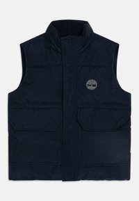Navy plavi bezrukavni prsluk s podstavom, visokim ovratnikom, dva prednja džepa s preklopom i malim logom drveta na lijevoj strani grudi.
