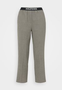 Harmaat ruutukuviolliset housut, joissa musta joustava vyötärönauha ja valkoinen "HILFIGER"-teksti. Suorat lahkeet, kevyt kangas, ei taskuja.