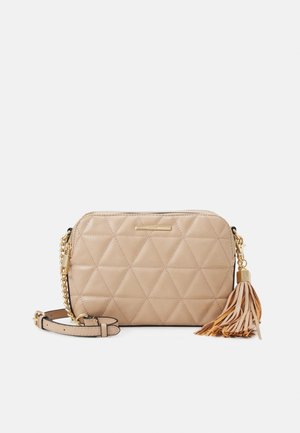 Beige quilted crossbody bag with gold chain strap and tassel detail, rectangular shape, and top zipper closure.