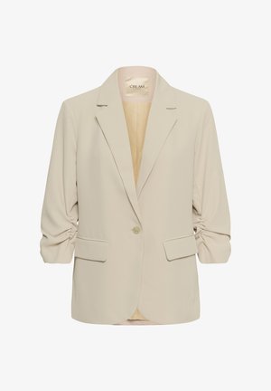 Krēmkrāsas sieviešu žakete ar rukojumiem trīs ceturtdaļu garuma piedurknēs, viena pogas aizdari, krokojumu apmalēm un divām priekšējām kabatām ar vāciņiem.