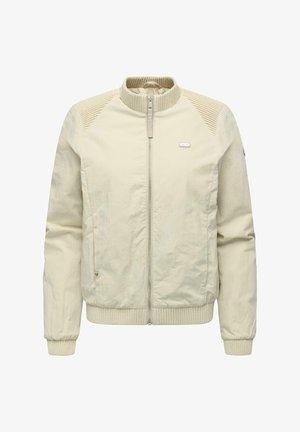 Kermanvärinen kevyt takki, jossa on ribbineulotut kaulus, hihansuut ja helma. Edessä vetoketju ja tekstuuriset olkapääpaneelit.